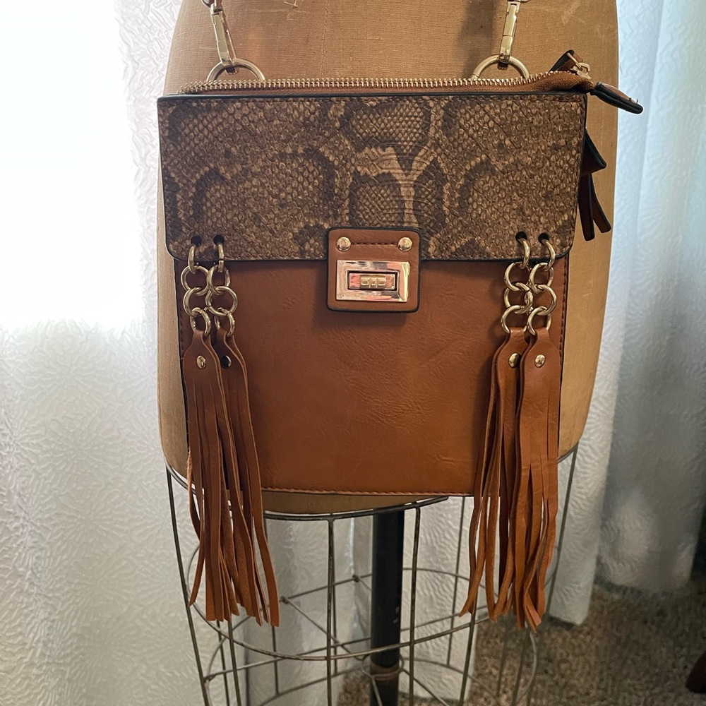 Boutique brand leather western style cross body purse.